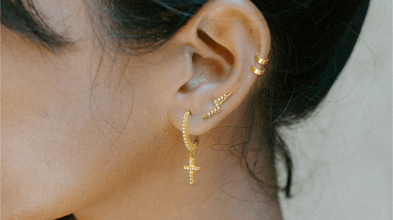 Unveiling the Enigma: Cross Huggie Earrings in Vogue